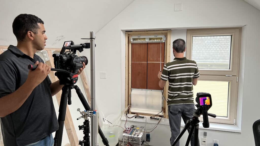 View of cSNAP prototype from inside House Zero with researcher measuring air flow