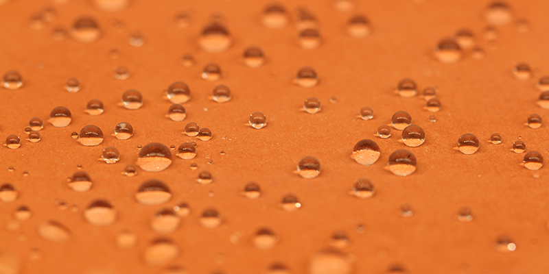 Detail shot of hydrophobic ceramic surface with water droplets
