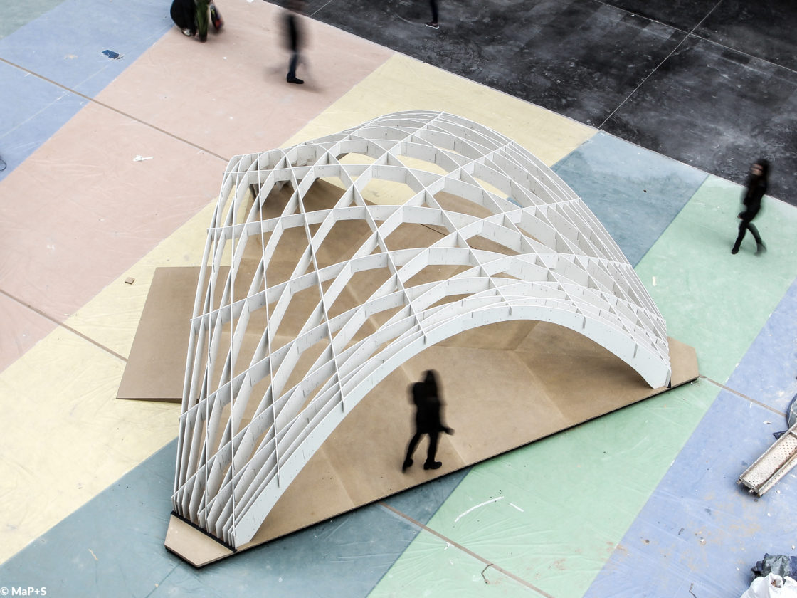 Photo of bird view of the Tile Grid Shell with people passing by