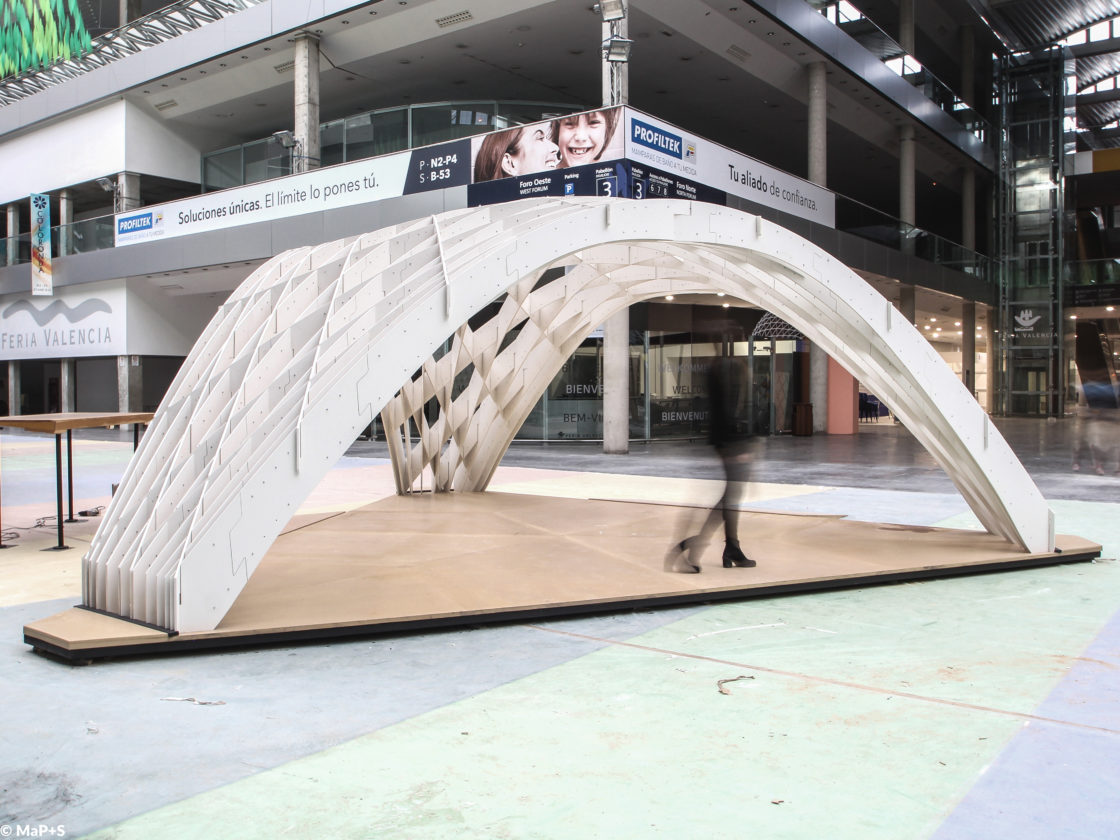 Photo of side view of the Tile Grid Shell with people passing by