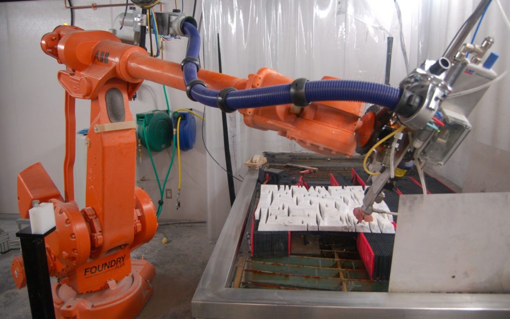 Photo of the robotic waterjet cutting the piece