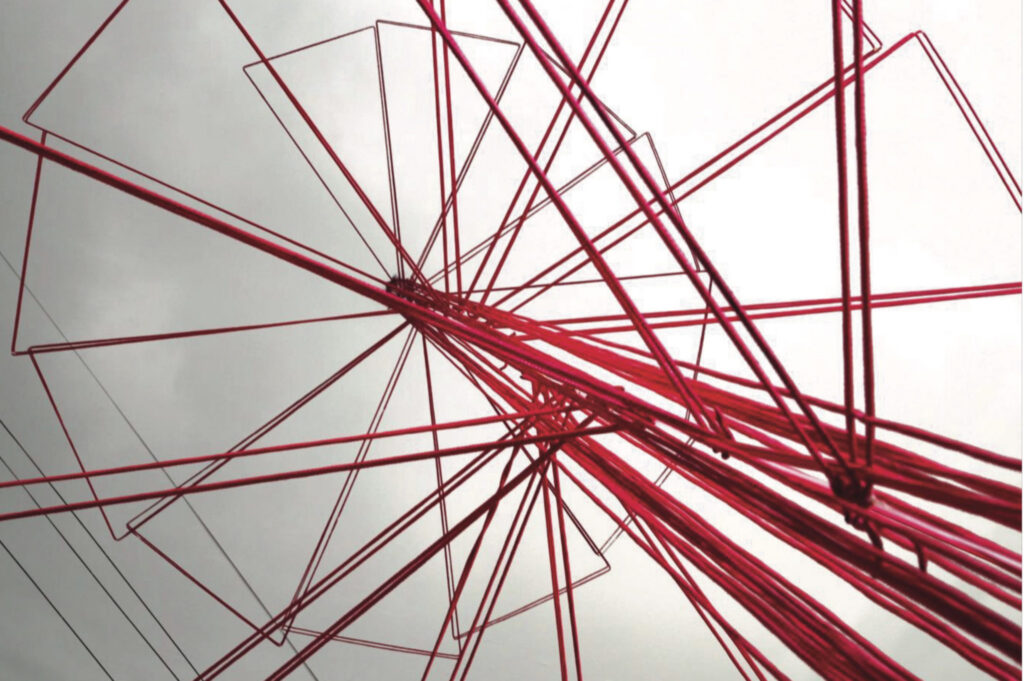 A view of a structural frame in red with a cloudy background