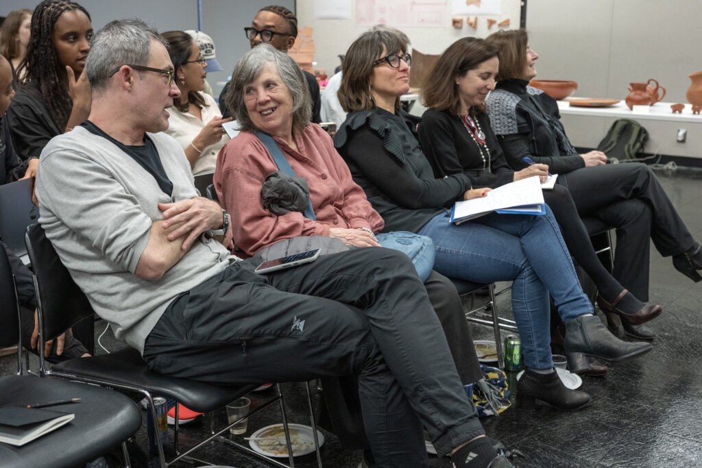 Group of attendees seated together, laughing during a session