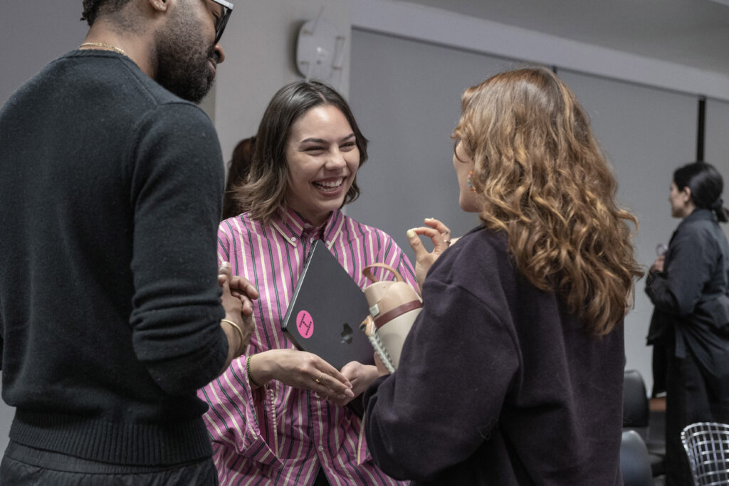 Andrea laughing with attendees following the event