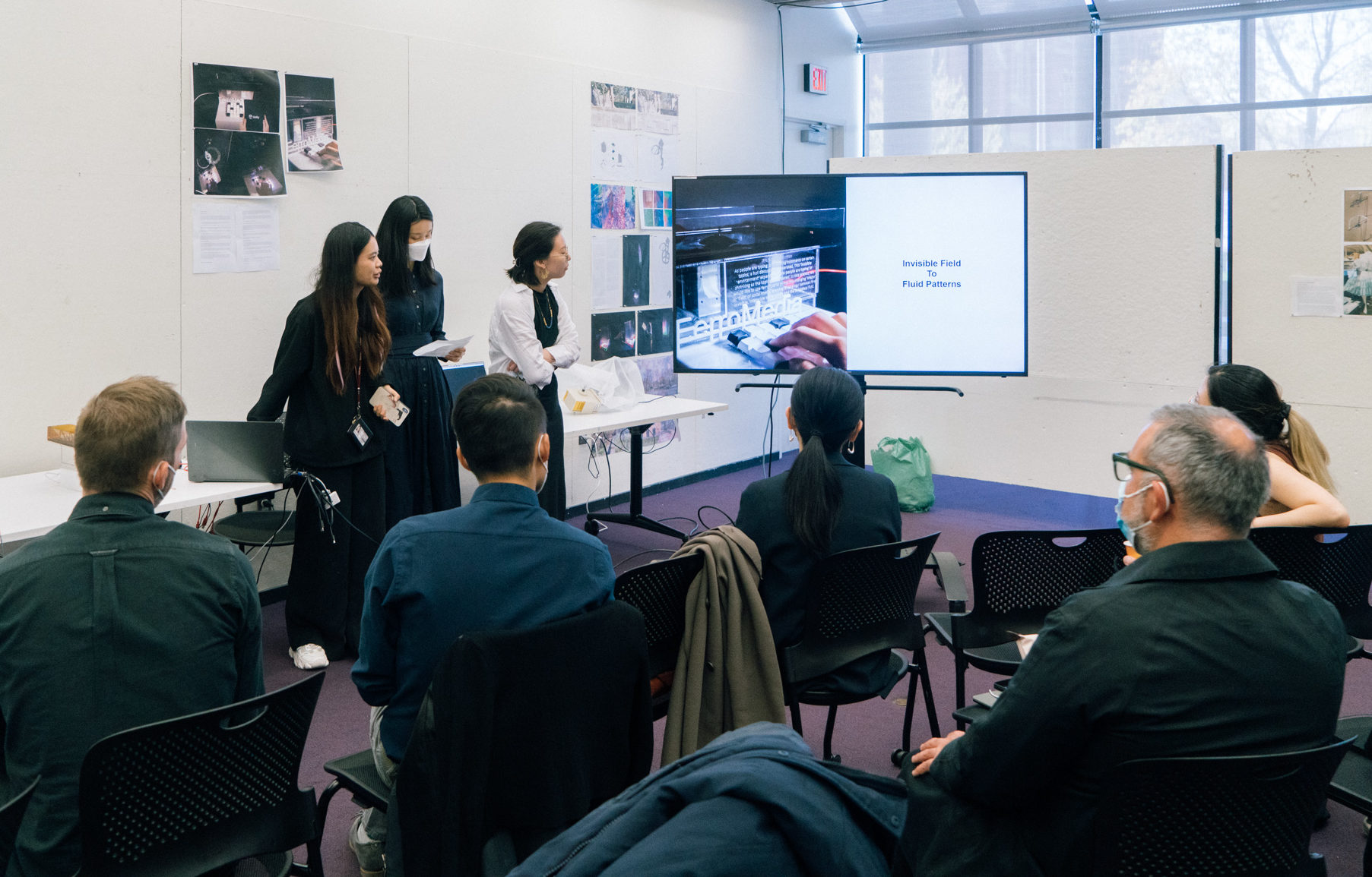 students presenting in front of a screen