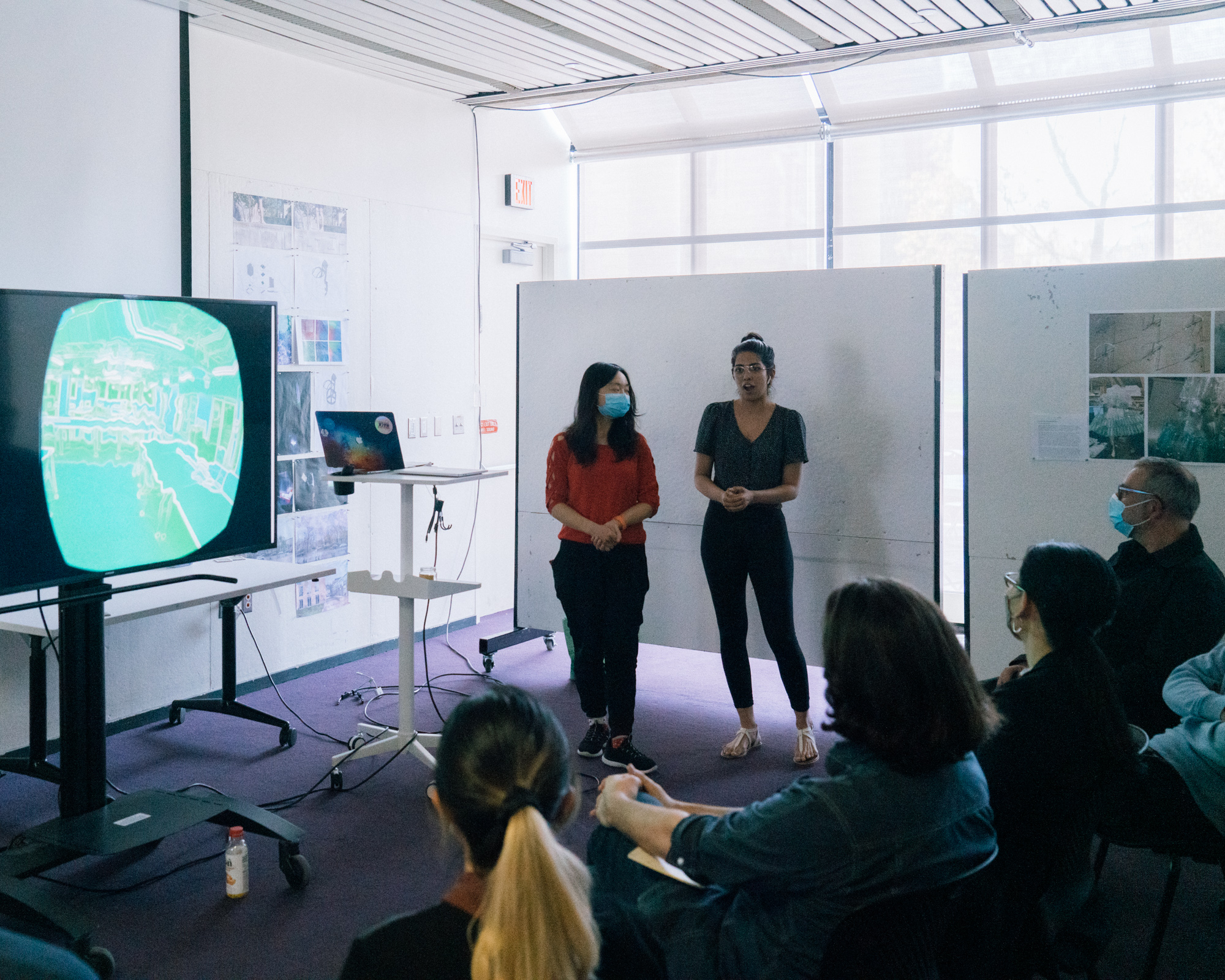 two students standing during a presentation