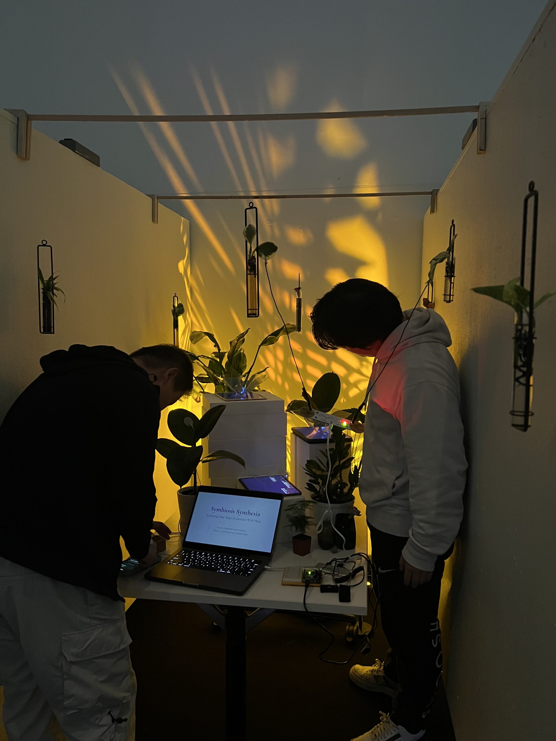 Two students interacting with plants