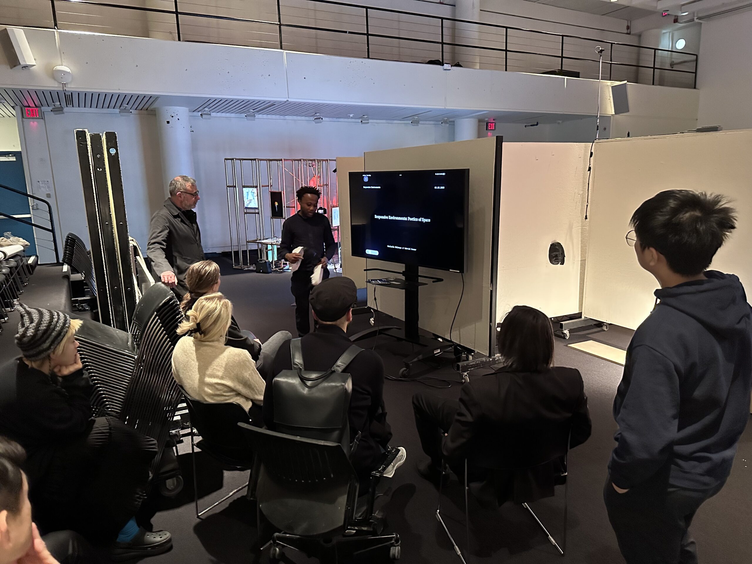 Student presenting infront of a panel.