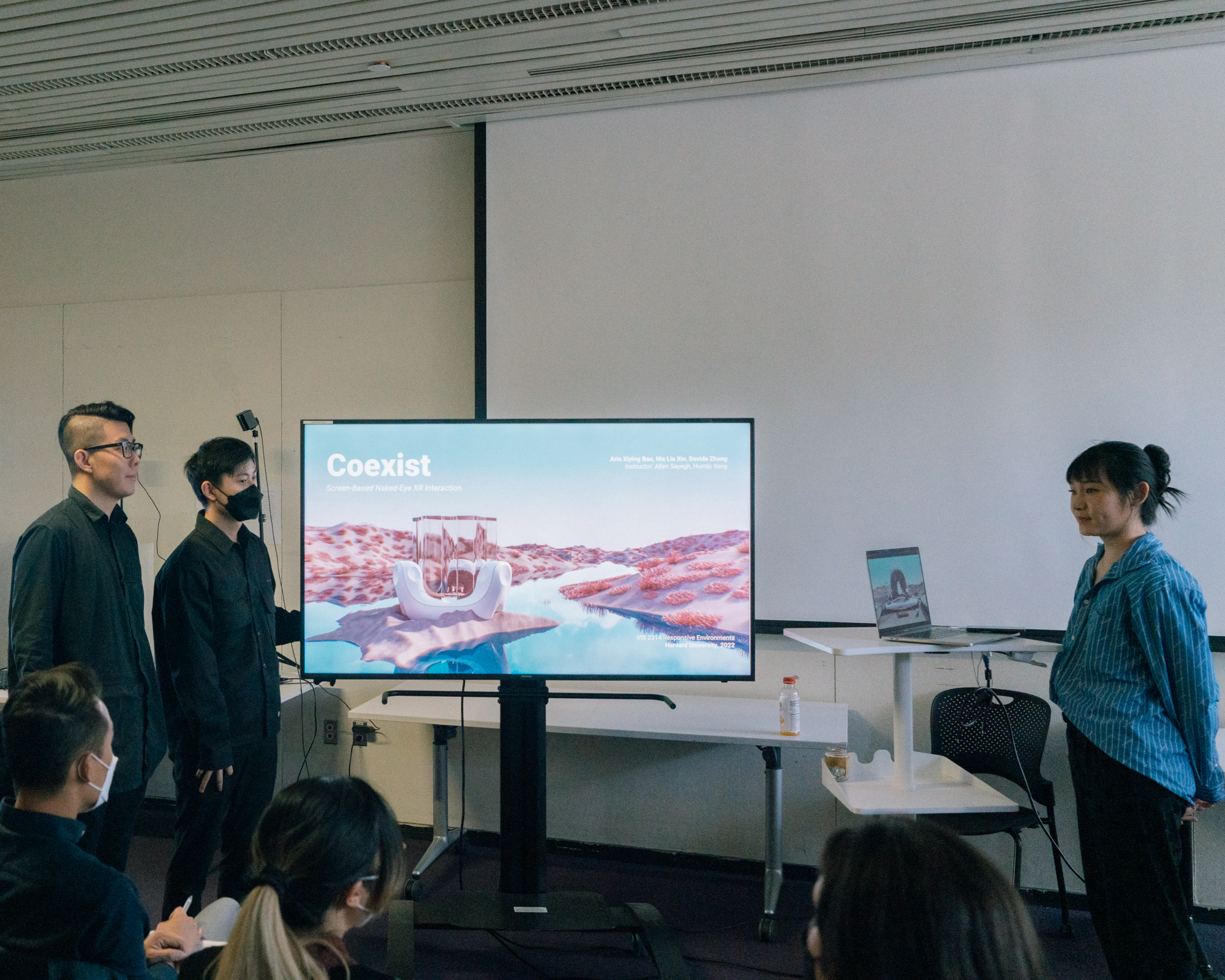 three students presenting a project.